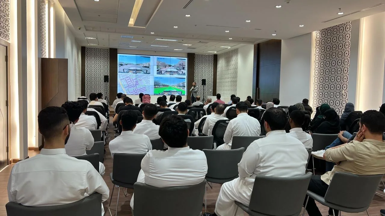 Ahmed Kamal presenting map and imagery data to a full room, 2025